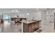 Open-concept kitchen featuring granite countertops, an island, and stainless steel appliances at 2966 Flying Blackbird Rd, Bartow, FL 33830