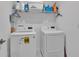 Bright laundry room includes a washing machine, dryer, and overhead storage shelf at 2966 Flying Blackbird Rd, Bartow, FL 33830