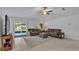 Comfortable living room with a ceiling fan, tile floors, and sliding glass doors to the patio at 2966 Flying Blackbird Rd, Bartow, FL 33830