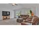 Cozy living room featuring tile floors, a ceiling fan, and comfortable seating at 2966 Flying Blackbird Rd, Bartow, FL 33830
