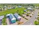 This aerial view shows the property with lush greenery, a tiki hut, and nearby homes at 3052 Wood Duck Dr, Polk City, FL 33868