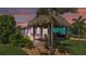 Charming home exterior with a tiki hut, perfect for outdoor entertaining and relaxation at 3052 Wood Duck Dr, Polk City, FL 33868