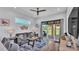 Cozy living room with a comfortable couch, stylish decor, and a sliding glass door to the outdoor patio at 3052 Wood Duck Dr, Polk City, FL 33868