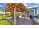 Enjoy outdoor dining in this tropical backyard Tiki hut, next to the BBQ and lush landscaping at 3052 Wood Duck Dr, Polk City, FL 33868