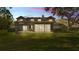 Enjoy the screened-in porch and lush green lawn at sunset at 3107 Stonewater Dr, Lakeland, FL 33803