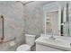 Powder room featuring patterned wallpaper, commode, and vanity at 3107 Stonewater Dr, Lakeland, FL 33803