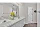 Bright bathroom with double sinks, white cabinets, large mirror, and updated fixtures at 3107 Stonewater Dr, Lakeland, FL 33803