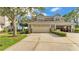 Charming townhome showcasing a two-car garage, inviting curb appeal, and lush landscaping at 3107 Stonewater Dr, Lakeland, FL 33803