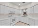Well-lit kitchen with white cabinets, appliances, and ample countertop space at 3107 Stonewater Dr, Lakeland, FL 33803