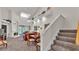 Open-concept living room with fireplace, dining area, and carpeted stairway at 3107 Stonewater Dr, Lakeland, FL 33803