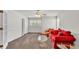 Bright living room with neutral walls, ceiling fan, and comfortable red sofa and chair at 3107 Stonewater Dr, Lakeland, FL 33803