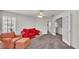 Cozy living room features a red sofa, chair, and lots of natural light at 3107 Stonewater Dr, Lakeland, FL 33803