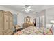 Bright bedroom features ceiling fan, floral bedding, and ensuite bathroom at 3107 Stonewater Dr, Lakeland, FL 33803