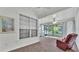 Charming sunroom with large windows offering beautiful views of the lake and tennis court at 3107 Stonewater Dr, Lakeland, FL 33803