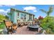 Spacious outdoor patio features a fire pit, Adirondack chairs, and views of the home and yard at 3270 Green Heron Dr, Polk City, FL 33868