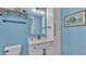 Stylish bathroom featuring a white vanity, black hardware, framed mirror, and blue accent wall at 3270 Green Heron Dr, Polk City, FL 33868
