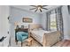 Light and airy bedroom with light wood furnishings, floral curtains, and a comfortable sitting area at 3270 Green Heron Dr, Polk City, FL 33868