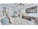 Comfortable bedroom with a large bed, a ceiling fan, and ample natural light at 3270 Green Heron Dr, Polk City, FL 33868