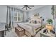 Calming bedroom with blue walls, a cozy bed, and a dedicated workspace at 3270 Green Heron Dr, Polk City, FL 33868