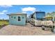 Exterior view of the home with a large RV parked in the driveway, and a small golf cart at 3270 Green Heron Dr, Polk City, FL 33868