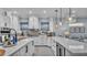 Open kitchen features quartz countertops, white cabinetry and stainless steel appliances with views to the living area at 3270 Green Heron Dr, Polk City, FL 33868