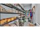 Walk-in pantry with metal shelving stocked with pantry staples, and small appliances on the bottom shelves at 3270 Green Heron Dr, Polk City, FL 33868