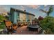 Outdoor patio area with comfortable seating and a cozy fire pit at 3270 Green Heron Dr, Polk City, FL 33868