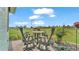 Cozy outdoor dining area with backyard views and well manicured landscaping and garden at 3270 Green Heron Dr, Polk City, FL 33868