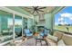 Relaxing porch features a grill, lounge furniture, ceiling fan, and views of the yard at 3270 Green Heron Dr, Polk City, FL 33868
