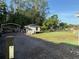 Backyard featuring a shed, garage and wooded area at 3646 Sherertz Road, Lakeland, FL 33810