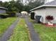 Gravel driveway leads to fenced backyard with work shed and mature trees at 3646 Sherertz Road, Lakeland, FL 33810