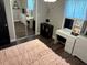 Comfortable bedroom with a large bed, ample natural light, and a mirrored closet at 3646 Sherertz Road, Lakeland, FL 33810