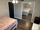 Bedroom with wood floors, mirrored closet doors, and a pink bedspread at 3646 Sherertz Road, Lakeland, FL 33810