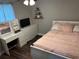 Cozy bedroom featuring a soft bed, vanity, and ample natural light at 3646 Sherertz Road, Lakeland, FL 33810