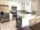 Bright kitchen with stainless steel appliances, white cabinetry, and a breakfast bar at 3646 Sherertz Road, Lakeland, FL 33810
