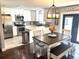 Bright kitchen with stainless steel appliances, white cabinetry, and a cozy dining area at 3646 Sherertz Road, Lakeland, FL 33810