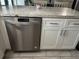 Kitchen area showcasing stainless steel dishwasher, gray countertops, and cabinetry at 3646 Sherertz Road, Lakeland, FL 33810