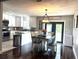 Bright kitchen with stainless steel appliances, white cabinetry, and a cozy dining area at 3646 Sherertz Road, Lakeland, FL 33810