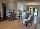 Open concept living and dining area with wood floors and gray color scheme at 3646 Sherertz Road, Lakeland, FL 33810