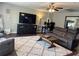 Spacious living room with a large TV, comfortable seating, and a workspace area at 3646 Sherertz Road, Lakeland, FL 33810