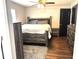 Comfortable main bedroom with modern furniture, wood-look flooring, and a ceiling fan at 3646 Sherertz Road, Lakeland, FL 33810