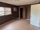 A bedroom featuring tiled floors and wood paneled walls at 3651 Rifle Range Rd, Winter Haven, FL 33880