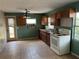 A view of the kitchen with an oven, cabinets, sink and a window at 3651 Rifle Range Rd, Winter Haven, FL 33880