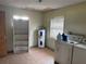 The laundry room is equipped with washer, dryer, water heater, and storage shelves at 3651 Rifle Range Rd, Winter Haven, FL 33880