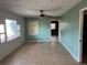 An empty living room with a ceiling fan, tiled floors, and a window at 3651 Rifle Range Rd, Winter Haven, FL 33880