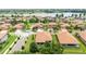 An aerial view of a residential neighborhood with tile roofs and a beautiful lake in the background at 3934 Aquilla Dr, Lakeland, FL 33810