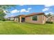Well-maintained backyard featuring lush green grass and a covered patio, perfect for outdoor living at 3934 Aquilla Dr, Lakeland, FL 33810