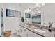 Well-lit bathroom featuring quartz countertops, vanity with white cabinets, modern fixtures, and stylish decor at 3934 Aquilla Dr, Lakeland, FL 33810