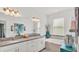 Bright bathroom featuring dual sinks, a soaking tub, and tasteful decor at 3934 Aquilla Dr, Lakeland, FL 33810