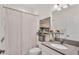 Cozy bathroom featuring a large mirror, vanity sink, and bathtub with a floral-patterned shower curtain at 3934 Aquilla Dr, Lakeland, FL 33810